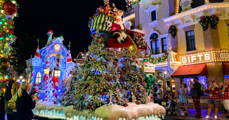Parade float featuring Santa Claus on a sleigh on Main Street U.S.A. at Disneyland Park at nighttime.